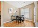 Bright dining area with a round table and four chairs, hardwood floors, and large window at 238 Walker Sw St # 35, Atlanta, GA 30313