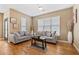 Living room with hardwood floors, gray sofas, and large window at 238 Walker Sw St # 35, Atlanta, GA 30313
