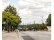 View of a street with trees, power lines, and a distant cityscape at 3155 Oakcliff Nw Rd, Atlanta, GA 30311