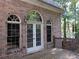 Brick house exterior with arched windows and white doors at 5335 Saville Nw Dr, Acworth, GA 30101