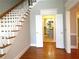 Bright entryway with hardwood floors, staircase, and view of kitchen at 5335 Saville Nw Dr, Acworth, GA 30101