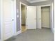 Bedroom with gray walls, carpet, and multiple doors at 5335 Saville Nw Dr, Acworth, GA 30101