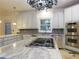 Spacious island kitchen with gas cooktop and stainless steel appliances at 5335 Saville Nw Dr, Acworth, GA 30101