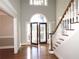 Two-story entryway with hardwood floors and elegant staircase at 5335 Saville Nw Dr, Acworth, GA 30101
