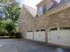 Brick home exterior showcasing a three-car garage at 5335 Saville Nw Dr, Acworth, GA 30101