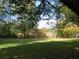 Large backyard with fenced area and mature trees at 5335 Saville Nw Dr, Acworth, GA 30101