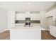 Modern kitchen with white cabinets, island, and stainless steel appliances at 2761 Hawthorne Way, College Park, GA 30337