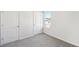 Well-lit bedroom with grey carpet and two closets at 2761 Hawthorne Way, College Park, GA 30337