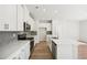 Modern kitchen with white cabinets, stainless steel appliances, and quartz countertops at 2761 Hawthorne Way, College Park, GA 30337