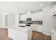 Modern kitchen with white cabinets, quartz countertops and island at 2761 Hawthorne Way, College Park, GA 30337