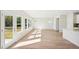 Bright dining room with hardwood floors and large windows, and kitchen at 2761 Hawthorne Way, College Park, GA 30337