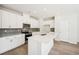 Modern kitchen with white cabinets, stainless steel appliances, and quartz countertops at 2761 Hawthorne Way, College Park, GA 30337