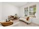 Cozy sitting area with a curved sofa and built-in shelving at 51 Airmont Dr, Sharpsburg, GA 30277