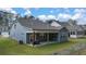 Gray house with covered patio and backyard at 51 Airmont Dr, Sharpsburg, GA 30277