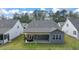 Home's rear elevation, showcasing patio and landscaping at 51 Airmont Dr, Sharpsburg, GA 30277