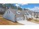 Side view of a charming gray-blue house with white garage doors at 51 Airmont Dr, Sharpsburg, GA 30277