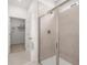 Large walk-in shower with neutral tile and glass enclosure at 51 Airmont Dr, Sharpsburg, GA 30277