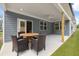 Covered patio with ceiling fan and seating area at 51 Airmont Dr, Sharpsburg, GA 30277