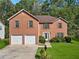 Brick two-story house with two car garage at 1240 Carriage Trace Cir, Stone Mountain, GA 30087