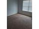 Spacious bedroom with large window and carpeted floor at 1833 Millstream Holw, Conyers, GA 30012