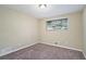 Spacious bedroom with neutral walls, carpet flooring, and a window at 3881 Nations Dr, Douglasville, GA 30135