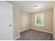 Bright bedroom with neutral walls, carpet, and a window with blinds at 3881 Nations Dr, Douglasville, GA 30135