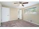 Cozy carpeted bedroom with a ceiling fan and access to a bathroom at 3881 Nations Dr, Douglasville, GA 30135