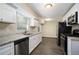 Modern kitchen with white shaker cabinets, granite countertops, and stainless steel appliances at 3881 Nations Dr, Douglasville, GA 30135