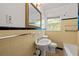 Retro bathroom with yellow tile, pedestal sink, and bathtub at 2490 Cascade Sw Rd, Atlanta, GA 30311
