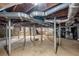 Unfinished basement area with exposed support beams and stone walls at 2490 Cascade Sw Rd, Atlanta, GA 30311
