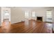 Hardwood floor living room with fireplace, kitchen, and access to the backyard at 2490 Cascade Sw Rd, Atlanta, GA 30311