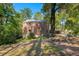 Brick home exterior showcasing backyard and large tree at 2490 Cascade Sw Rd, Atlanta, GA 30311