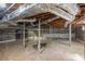 Unfinished basement with exposed support beams and stone foundation at 2490 Cascade Sw Rd, Atlanta, GA 30311