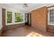 Brick sunroom features tile flooring and multiple windows at 2490 Cascade Sw Rd, Atlanta, GA 30311