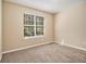 Bright bedroom with neutral walls, carpet flooring, and a large window at 3184 Lower Creek Dr, Douglasville, GA 30135