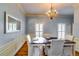 Elegant dining room featuring hardwood floors, a large chandelier, and a formal table setting at 965 Sundew Se Dr, Conyers, GA 30013