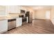 Modern kitchen featuring stainless steel appliances and wood-look flooring at 2112 Royal Fox Way, Decatur, GA 30032