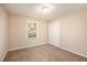 Well-lit bedroom featuring neutral walls and carpet at 2112 Royal Fox Way, Decatur, GA 30032