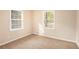 Bedroom with neutral decor, carpet, and two windows at 2112 Royal Fox Way, Decatur, GA 30032