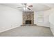 Living room features a corner stone fireplace and neutral carpet at 5035 Fairforest Dr, Stone Mountain, GA 30088