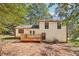 Back of house with deck and wooded backyard at 5035 Fairforest Dr, Stone Mountain, GA 30088