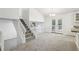 Open-concept living area with a staircase and access to a deck at 5035 Fairforest Dr, Stone Mountain, GA 30088