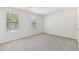 Bedroom with neutral walls, carpet, and two windows at 5035 Fairforest Dr, Stone Mountain, GA 30088