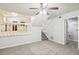 Open living space with a view into the kitchen and stairs to upper level at 5035 Fairforest Dr, Stone Mountain, GA 30088