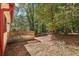 Small deck and fenced backyard with mature trees at 5035 Fairforest Dr, Stone Mountain, GA 30088