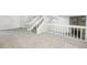 Living area showcasing stairs, fireplace, and neutral carpeting at 5035 Fairforest Dr, Stone Mountain, GA 30088
