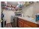 Convenient laundry room with washer, dryer, and storage shelves at 204 Somerton Pl, Cumming, GA 30040