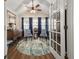 Bright sunroom with hardwood floors, two comfy chairs, and a circular rug at 204 Somerton Pl, Cumming, GA 30040