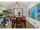 Dining room with hardwood floors, a large wooden table, and modern light fixture at 204 Somerton Pl, Cumming, GA 30040
