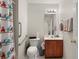 Accessible bathroom with shower, grab bars, and updated vanity at 204 Somerton Pl, Cumming, GA 30040